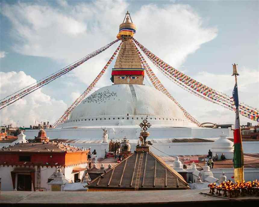 Nepali stupa and prayer flags under open sky, with no people in frame